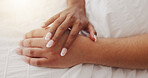 Hands, touch and couple relax on bed for intimacy, partner affection and connection in morning. Closeup, people and holding with cuddle for care, romance and bonding for marriage commitment at house