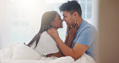 Buy stock photo Couple, nose touch and love in bedroom together, affection and bonding with commitment for trust in home. Romance, partner and happy in healthy relationship, eskimo kiss and interracial people in bed