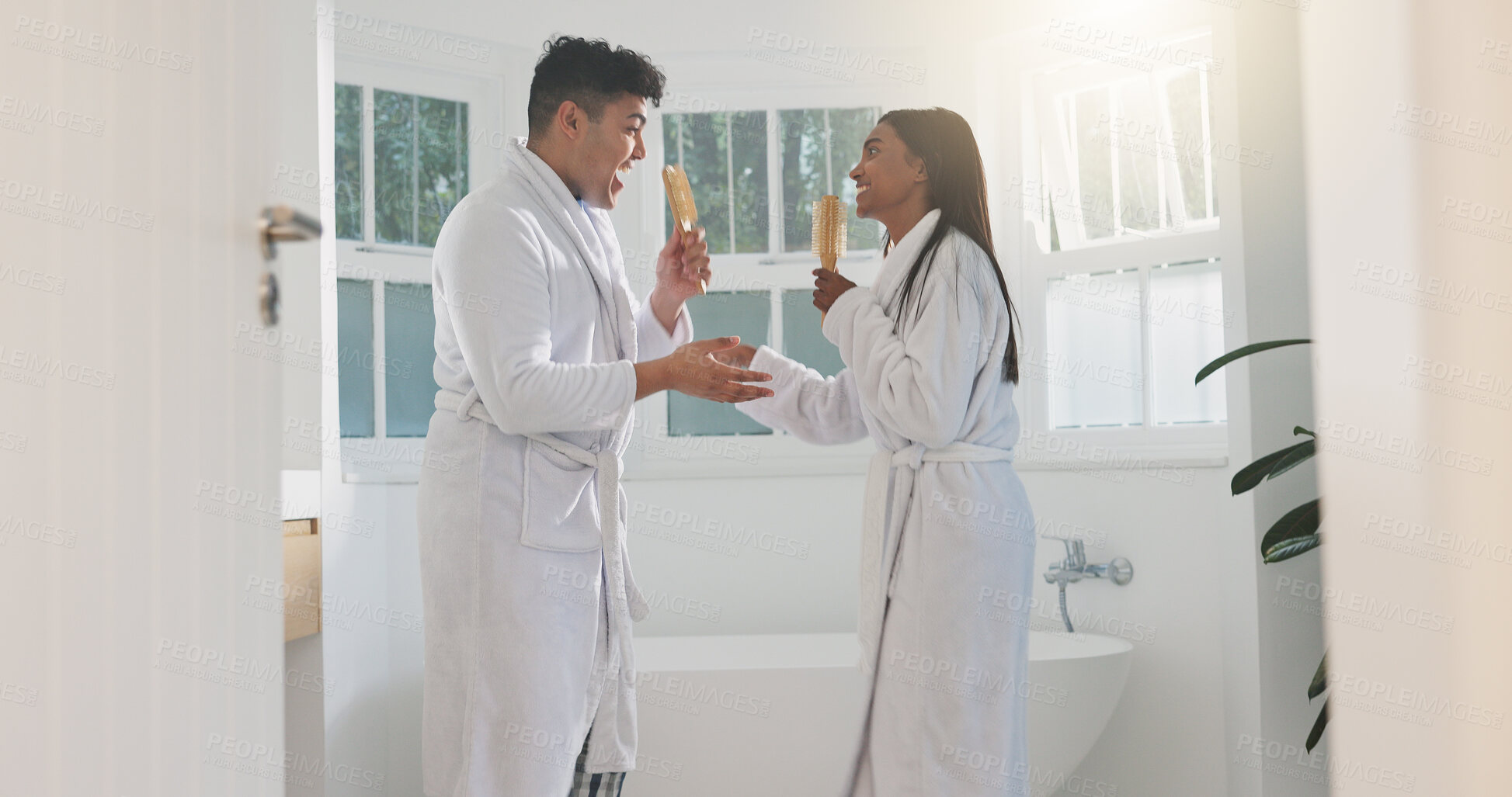 Buy stock photo Singing, love and couple in bathroom, funny and bonding together with happiness, care and smile. Home, people and man with woman, morning or karaoke with relationship, energy or romance with marriage