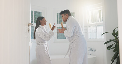 Buy stock photo Singing, love and couple in bathroom, karaoke and bonding together with happiness, marriage and funny. Home, people and man with woman, morning and smile with relationship, energy or romance with fun