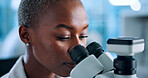 Laboratory, black woman and scientist with microscope for research, medical experiment or test sample. Face, female person and genetic engineer with biotech for pharmaceutical, investigate or science