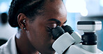 Laboratory, black woman and scientist with microscope for science, medical experiment or test sample. Face, female person and genetic engineer with biotech for pharmaceutical, investigate or research