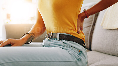 Buy stock photo Woman, hand and back pain with injury on sofa for discomfort, muscle tension or strain at home. Closeup, female person or ache with sore spine for pressure, bad posture or bruise on couch at house
