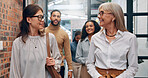 Walking, discussion and business people in office hallway for meeting, talking and planning. Creative startup, professional and manager with workers speaking for teamwork, collaboration and project