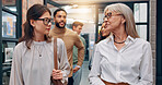 Walking, talking and business people in office hallway for meeting, discussion and planning. Creative startup, professional and manager with workers speaking for teamwork, collaboration and project