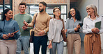 Walking, team and business people in hallway for planning, talking and discussion. Creative startup, professional and men and women in meeting for project ideas, collaboration and communication