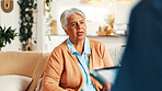 Tablet, discussion and mature woman with nurse for medical consultation on sofa in home. Technology, conversation and caregiver explain with elderly patient, diagnosis and assisted living at house