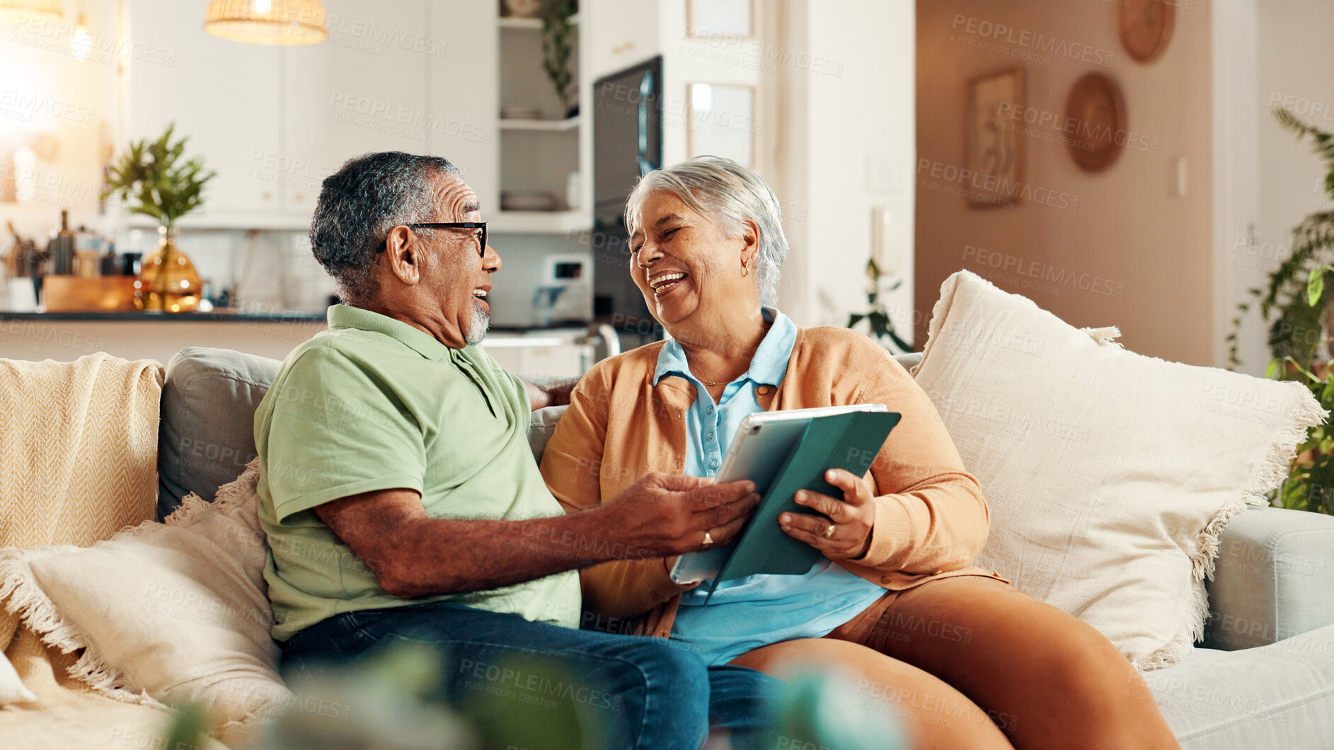 Buy stock photo Tablet, conversation and senior couple on sofa with reading online news together in morning. Happy, technology and elderly man with woman for scrolling on app with bonding in living room in home.