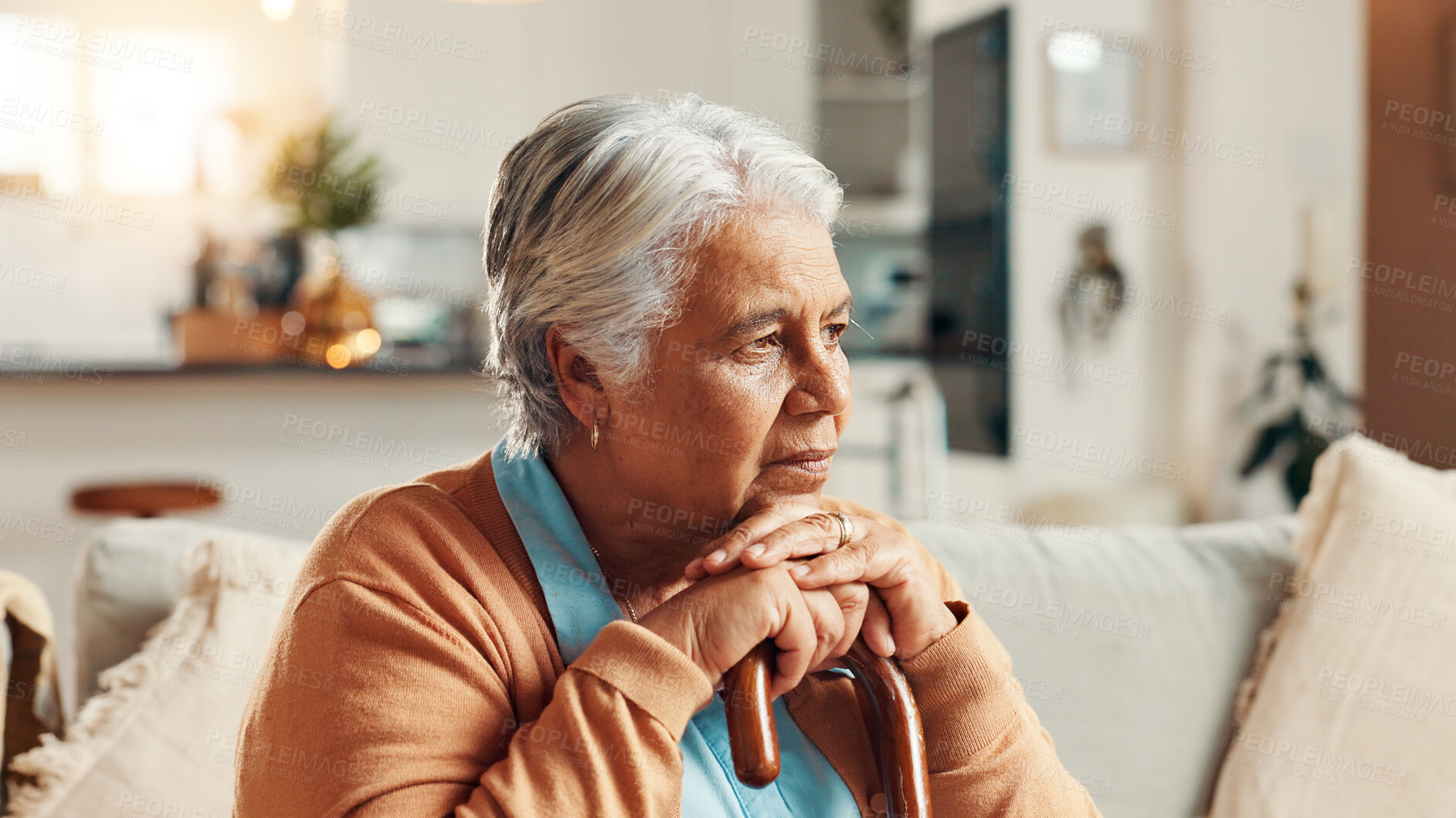 Buy stock photo Sad, senior woman and thinking with cane in home for retirement loneliness, grief and nostalgia with memory. Stress, mental health or elderly person with walking stick on sofa for loss and reflection