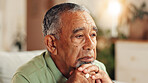 Sad, senior man or thinking in home with retirement loneliness, grief or remember memory with nostalgia. Face, mental health or elderly person with depression on sofa for loss, reflection or dementia