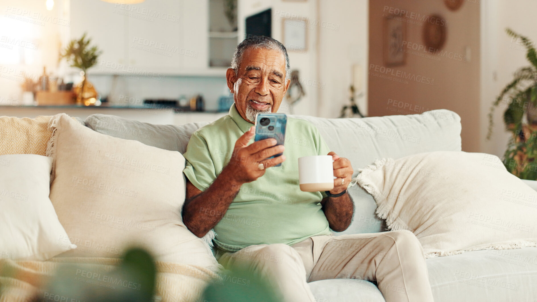 Buy stock photo Home, coffee and senior man with smartphone, relax and texting with tech in living room, smile and online. Communication, retirement and elderly person with mobile for chat, tea and message on app