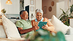 Tablet, talking and senior couple on sofa reading online news together in morning. Happy, digital technology and elderly man with woman for scrolling on app with bonding in living room in home.