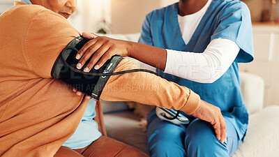 Buy stock photo Mature woman, nurse and hands for blood pressure in nursing home, medical care and health exam on arm. Living room, diagnosis and conversation with healthcare, wellness support and monitoring or test