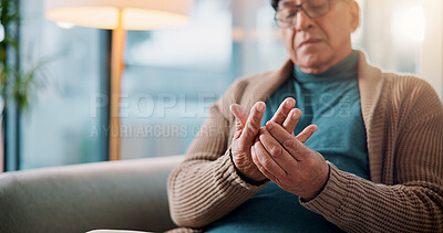Buy stock photo Hands, home and old man with pain, muscle tension or inflammation with arthritis in living room. Fibromyalgia, pensioner or elderly person on sofa, osteoporosis or parkinson disease with injury