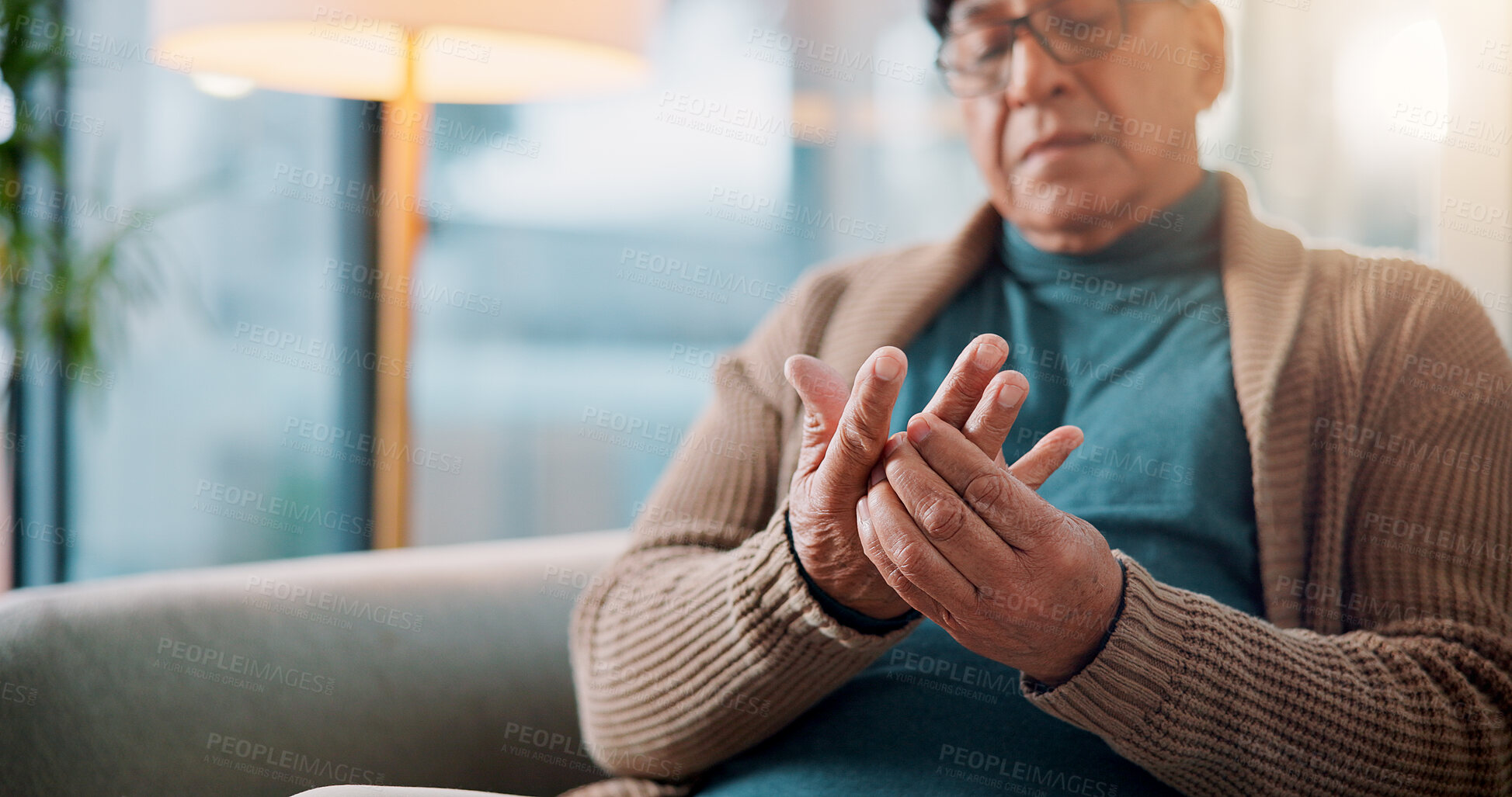 Buy stock photo Hands, home and old man with pain, muscle tension or inflammation with arthritis in living room. Fibromyalgia, pensioner or elderly person on sofa, osteoporosis or parkinson disease with injury