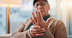Hands, home and old man with hand pain, arthritis and inflammation with fibromyalgia. Muscle tension, pensioner and elderly person on couch, osteoporosis and parkinson disease with joint injury