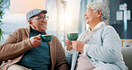 Happy old couple, talking and drinking coffee in home for relax, story and enjoy latte together. Senior man, woman and tea cup in living room for retirement, laughing and morning chat with funny joke