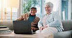 Senior couple, laptop and happy on sofa in home with movie, streaming and laugh at funny video in lounge. Elderly man, woman and relax with computer, film or subscription in retirement at apartment