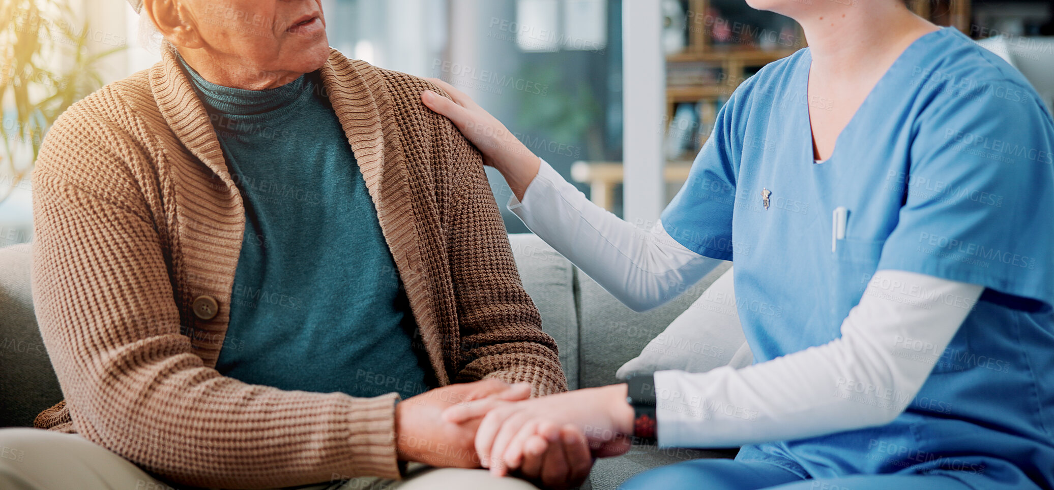 Buy stock photo Home, caregiver and old man with holding hands for support, empathy and console after diagnosis news. Sofa, nurse and senior patient with consultation for wellness, compassion or trust in living room