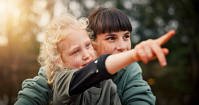 Buy stock photo Mom, child and pointing with nature for sightseeing adventure, journey or bird watching in forest. Mother, parent or girl kid showing with finger for look, indication or outdoor bonding at park