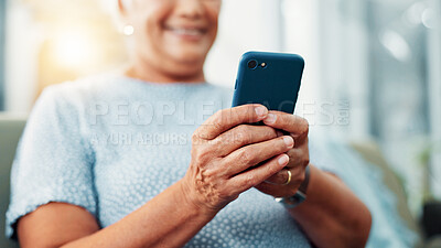 Buy stock photo Senior woman, hands and typing with phone for game, word search or online entertainment on sofa at home. Closeup, elderly or female person with smile on mobile smartphone for chatting or texting app
