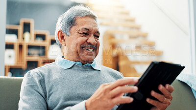 Buy stock photo Tablet, relax and senior man on sofa in home learning for online communication, networking or social media. Happy, digital technology and elderly male person in living room reading news on app