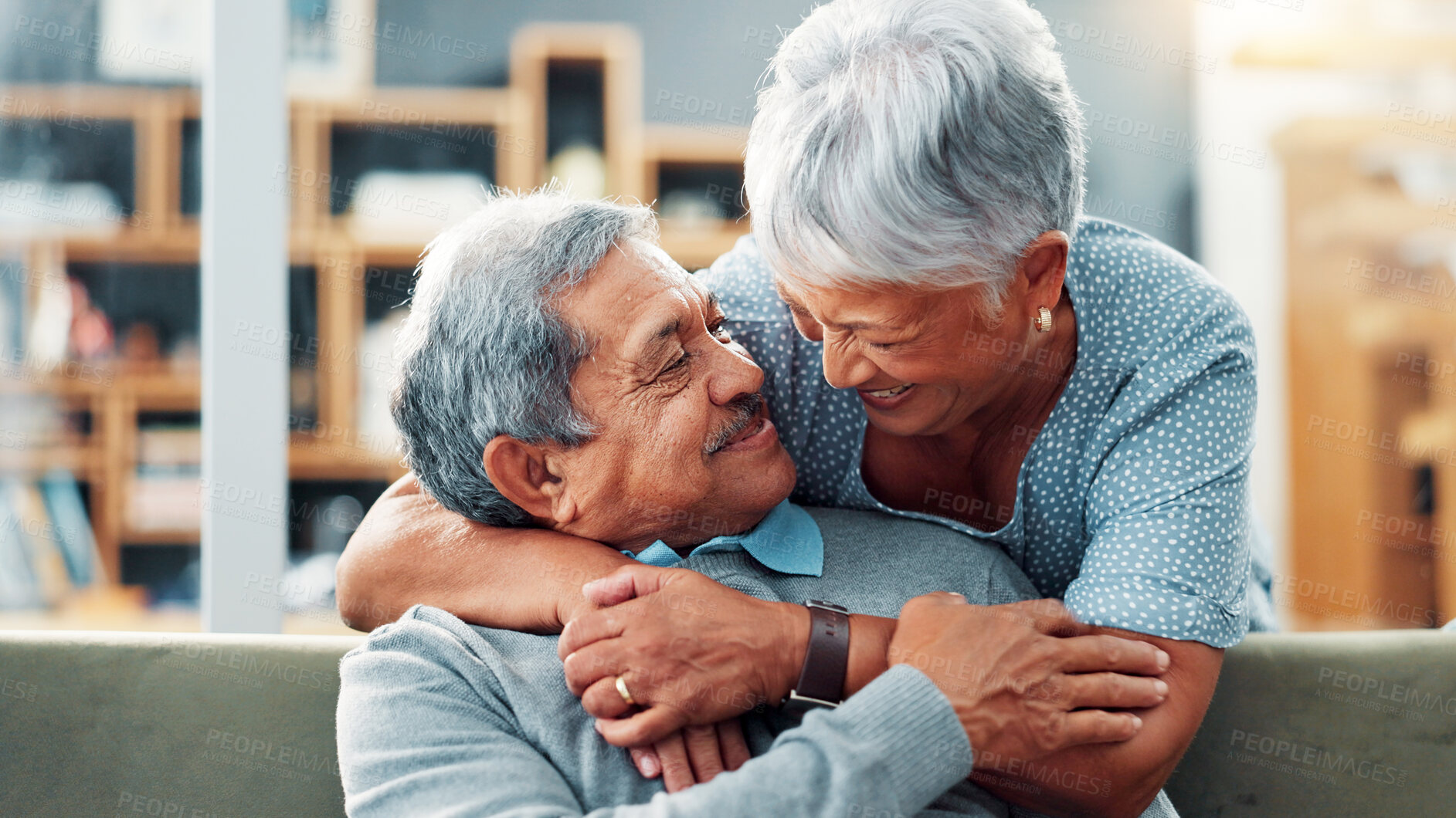 Buy stock photo Love, hug and senior couple in home, smile and commitment for relationship, bonding and relax in lounge. House, old man and care for woman in living room, embrace and retirement for elderly people