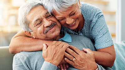 Buy stock photo Relax, hug and senior couple in home, smile and commitment for relationship, bonding and love in lounge. House, old man and care for woman in living room, embrace and retirement for elderly people