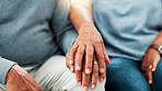 Comfort, empathy and hands of couple in living room of home together for bonding, love or support. Compassion, sympathy and trust with senior people closeup in apartment for connection or healing