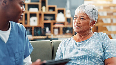 Buy stock photo Senior woman, nurse and conversation in home for healthcare, medical support and wellness. Retirement, patient and talking with caregiver in living room for help, checkup and insurance with tablet