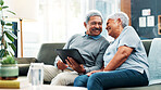 Mature couple, smile and happy with tablet, streaming and communication in living room. People, senior man and woman with funny meme, couch and house together in retirement with digital technology