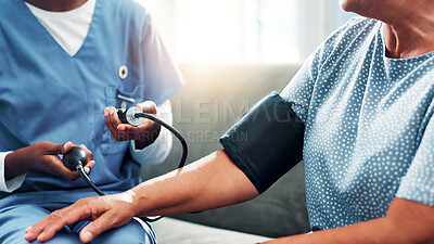 Buy stock photo Mature woman, nurse and hands for blood pressure in nursing home, medical care or health exam on arm. Living room, diagnosis or conversation for healthcare, cardiovascular support or heart monitoring