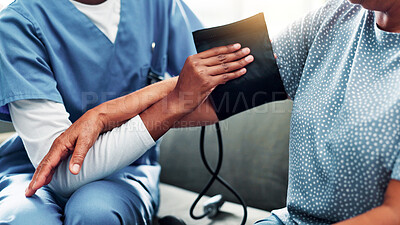 Buy stock photo Senior woman, caregiver and hands for blood pressure in nursing home, medical care or health exam. Living room, diagnosis or conversation for healthcare, cardiovascular support or heart monitoring
