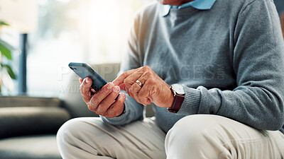 Buy stock photo Senior man, hands and typing with phone on sofa for game, word search or social media app at home. Closeup, male person or elderly user browsing with mobile smartphone for connection or network