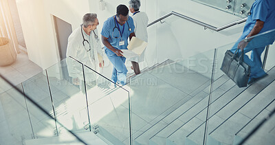 Buy stock photo Paperwork, doctor and nurse walk on stairs with documents in hospital lobby. Above discussion, medical professional men on steps with files for healthcare, teamwork and collaboration in clinic