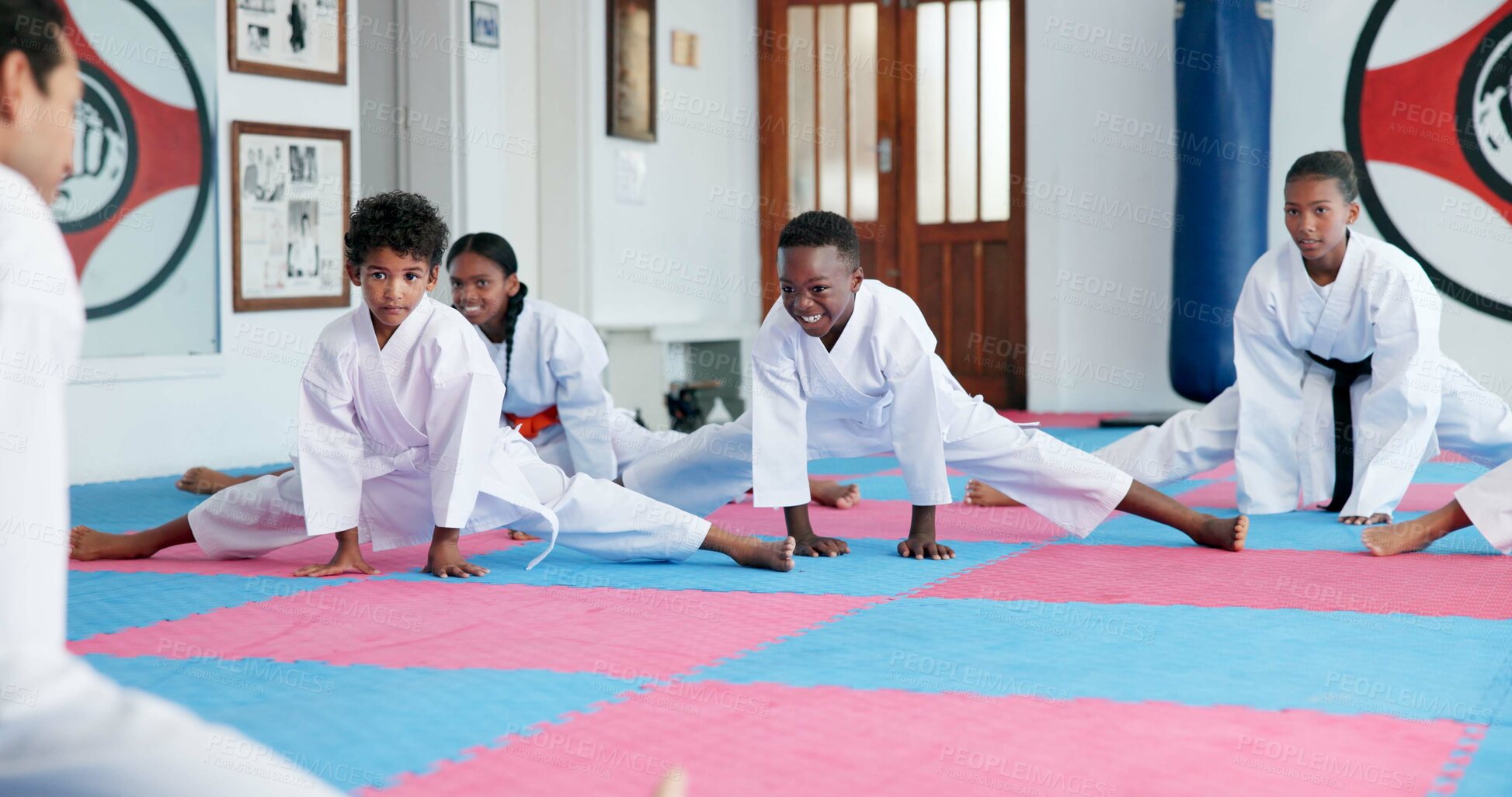 Buy stock photo Kids, sensei and stretching in karate class for preparation, start lesson or warm up for martial arts. Girls, boys and coach and students in dojo ready for self defense training, taekwondo and sports