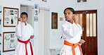 Girl, children or karate student in dojo for combat, fighting tournament or sports training with dedication. Exercise, fitness workout or kids in gym for martial arts education, development or growth