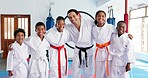 Sensei, portrait and man with kids in karate class, self defense or martial arts with youth for combat education. Taekwondo pride, smile and male instructor with student children for coaching in dojo