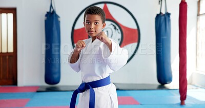 Buy stock photo Karate, portrait and ready with boy student in dojo for combat, martial arts or sports training. Exercise, fitness and workout with serious African child in gym for education, development or growth
