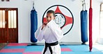 Karate, portrait and ready with girl student in dojo for combat, martial arts or sports training. Exercise, fitness and workout with serious child in gym for education, development or growth