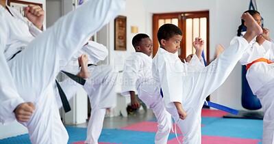 Buy stock photo Fitness, karate and kicking with kids in class for combat, fighting or self defense training. Development, exercise or growth with children in sports dojo for martial arts lesson or practice