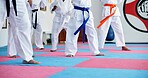 Karate, kids and legs at dojo for fighting, self defense or fitness training together. Practice, children and body of students with kicking exercise for martial arts, workout or aikido lesson at gym.