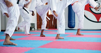 Buy stock photo Karate, children and legs at dojo for fighting, self defense or fitness training together. Practice, kids and body of students with kicking exercise for martial arts, workout or aikido lesson at gym.