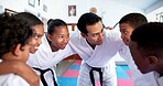 Children, teacher and huddle together in dojo for martial arts training, self defense or fighting competition. Kids, motivation and planning with support for taekwondo challenge or community karate