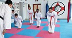 Bow, respest and children in karate dojo with sensei for self defense, tradition or custom for martial arts. Coach, students and prepare for fight, discipline and taekwondo with fitness or sports