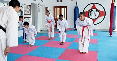 Buy stock photo Bow, respest and children in karate dojo with sensei for self defense, tradition or custom for martial arts. Coach, students and prepare for fight, discipline and taekwondo with fitness or sports
