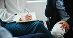 Business people, hands and writing with book in support group for counseling or therapy session at office. Employees, colleagues or therapist taking notes in meeting for rehabilitation at workplace