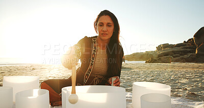 Buy stock photo Meditation, sound therapy and woman with bowls at beach for mindfulness, spiritual cleanse and energy. Nature, morning ritual and person with frequency for healing, balance and wellness by ocean