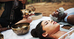 Meditation, sound therapy and people with bowls on floor for mindfulness, spiritual cleanse and energy. Nature, ritual and healer with men and women with frequency for healing, balance and wellness