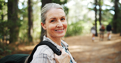Buy stock photo Hiking, forest and portrait of mature woman in nature with backpack for exercise, walking and health. Fitness, travel and person in woods for trekking, adventure and journey outdoor for wellness